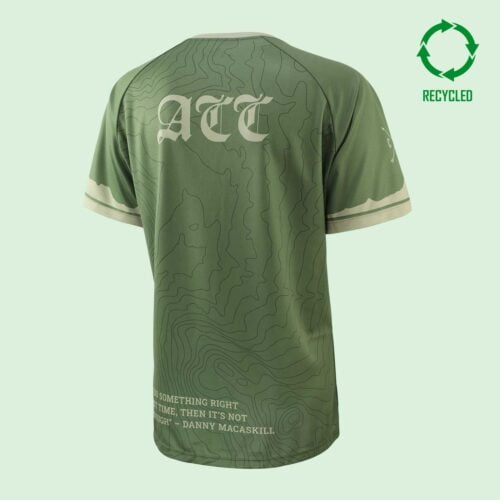 Back view of green, short-sleeved moutain bike T shirt with 3 letters across upper back and a circular "recycled" logo in upper right corner of the image